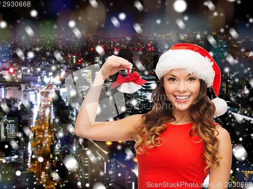 Image of smiling woman in santa helper hat and jingle bells