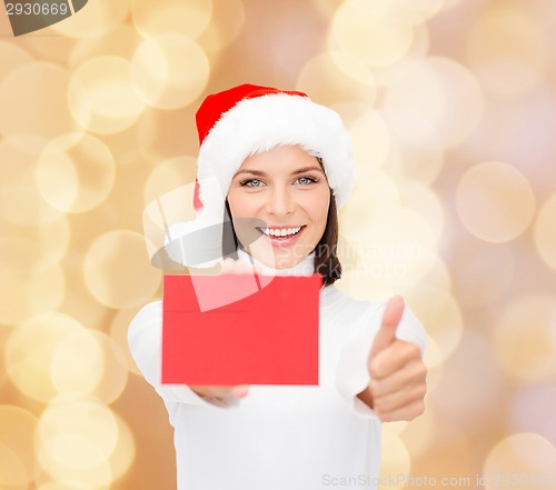 Image of woman in santa helper hat with blank red card