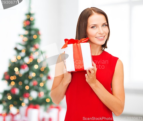 Image of smiling woman in red dress with gift box