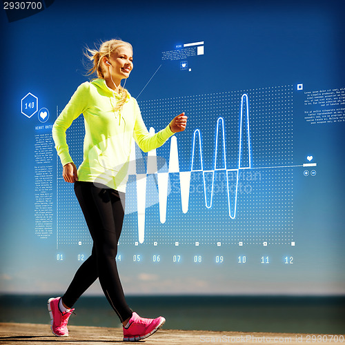 Image of smiling woman doing sports outdoors with earphones