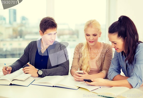 Image of smiling students with notebooks at school