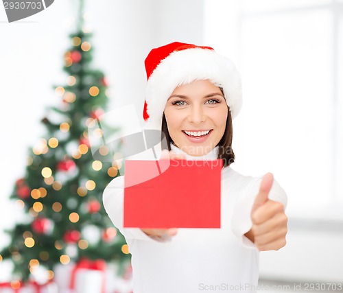 Image of woman in santa helper hat with blank red card