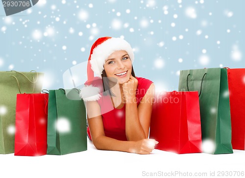 Image of woman in red shirt with shopping bags