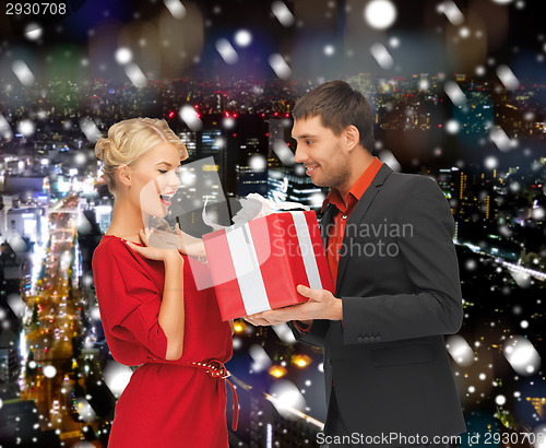 Image of smiling man and woman with present