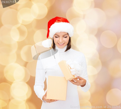 Image of smiling woman in santa helper hat with gift box