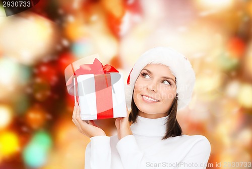 Image of smiling woman in santa helper hat with gift box