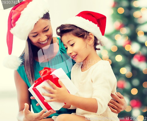 Image of happy mother and child girl with gift box