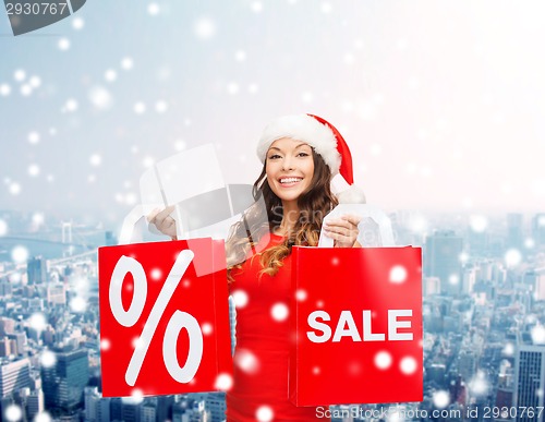 Image of woman in red dress with shopping bags