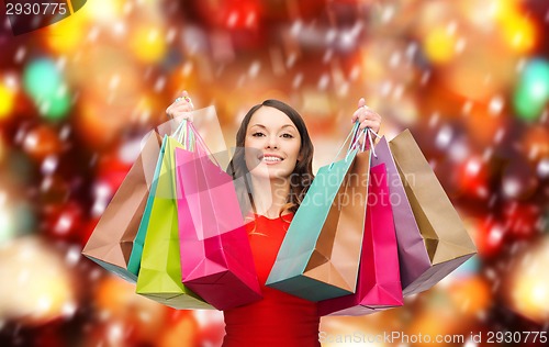Image of woman in red dress with colorful shopping bags