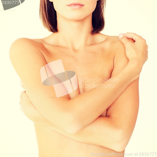 Image of woman with perfect skin and hands over breast