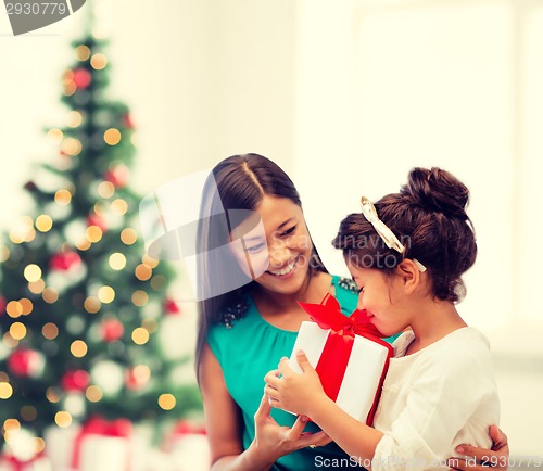 Image of happy mother and child girl with gift box