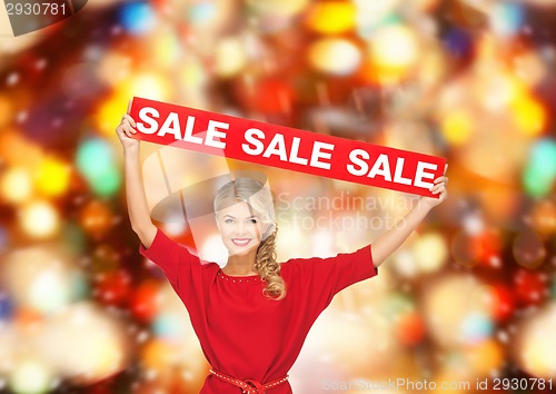 Image of woman in red dress with sale sign