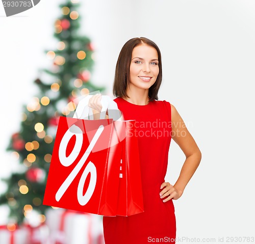 Image of woman in red dress with shopping bags