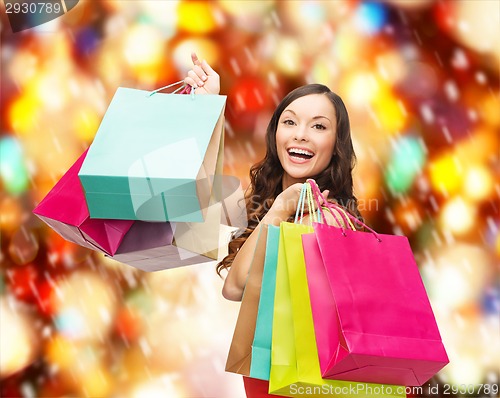 Image of woman in red dress with colorful shopping bags