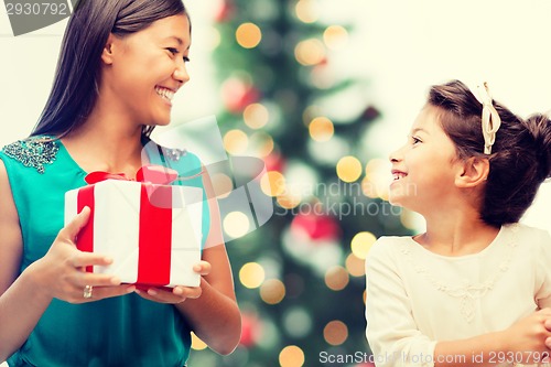 Image of happy mother and child girl with gift box