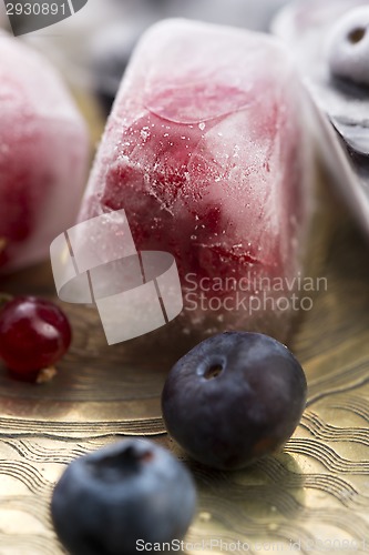 Image of Fresh berry fruits frozen in ice cubes