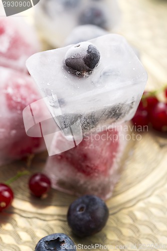 Image of Fresh berry fruits frozen in ice cubes