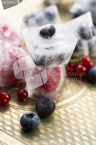 Image of Fresh berry fruits frozen in ice cubes