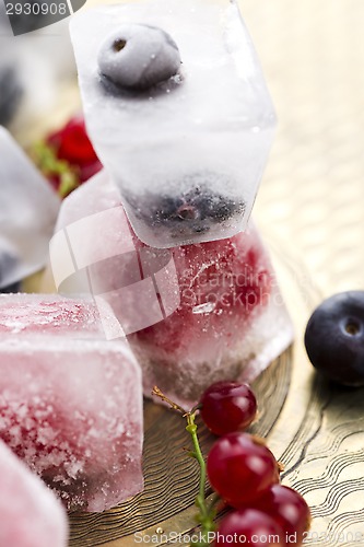 Image of Fresh berry fruits frozen in ice cubes