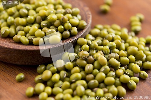 Image of Mung beans over wooden spoon