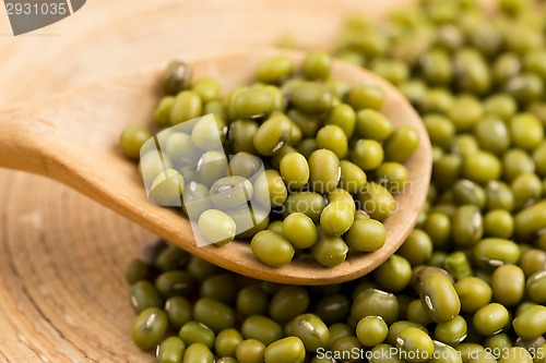 Image of Mung beans over wooden spoon