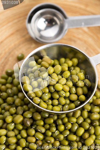 Image of Mung beans over wooden spoon