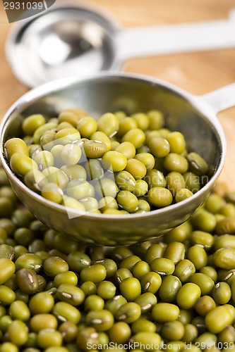 Image of Mung beans over wooden spoon