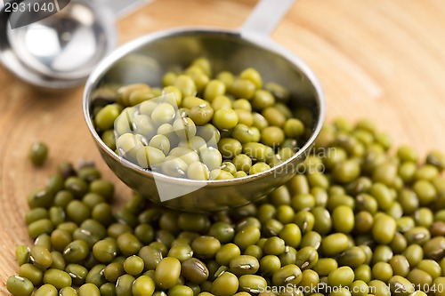 Image of Mung beans over wooden spoon