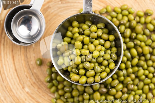 Image of Mung beans over wooden spoon