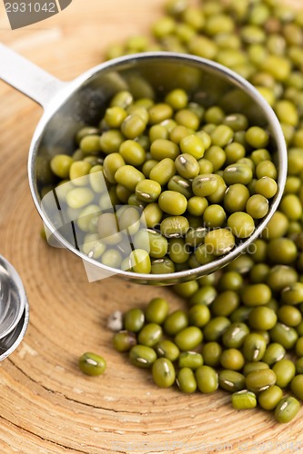 Image of Mung beans over wooden spoon