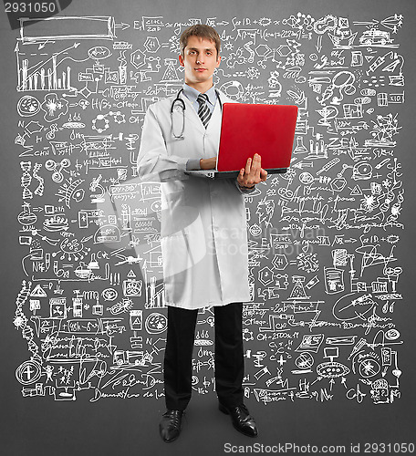 Image of doctor male in suit with laptop in his hands