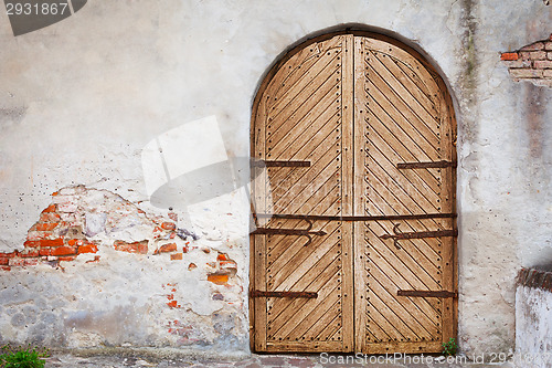 Image of Wooden door in an old style. Courtyard of old castle