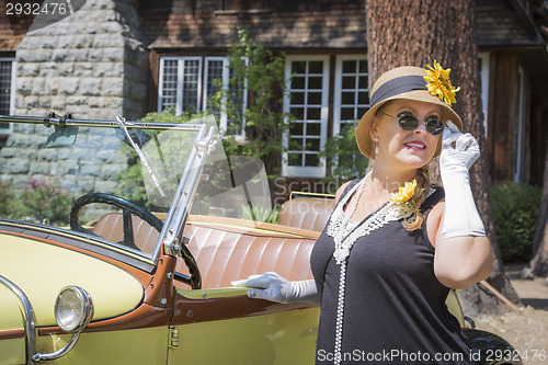 Image of Attractive Woman in Twenties Outfit Near Antique Automobile