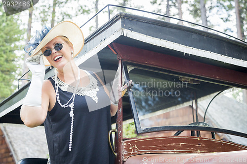 Image of Attractive Woman in Twenties Outfit Near Antique Automobile