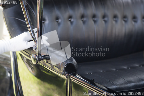 Image of Female Hand on Leather of Antique Model T Automobile Seat