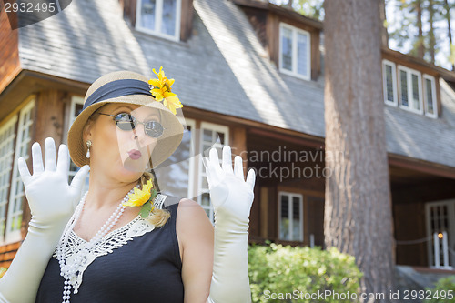 Image of Attractive Woman in Twenties Outfit Near Antique House