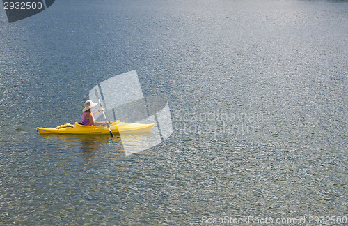 Image of Woman Kayaking on Beautiful Mountain Lake.