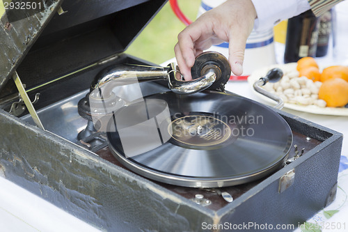 Image of Man Starting Antique Phonograph Record Player