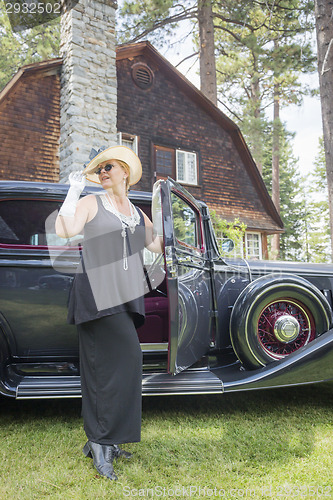 Image of Attractive Woman in Twenties Outfit Near Antique Automobile