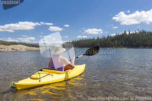 Image of Woman Kayaking on Beautiful Mountain Lake.