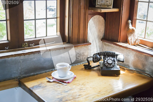 Image of Antique Phone and Cup of Coffee in Old Kitchen Setting