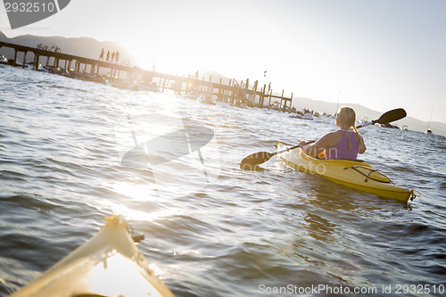 Image of Woman Kayaking on Beautiful Mountain Lake.