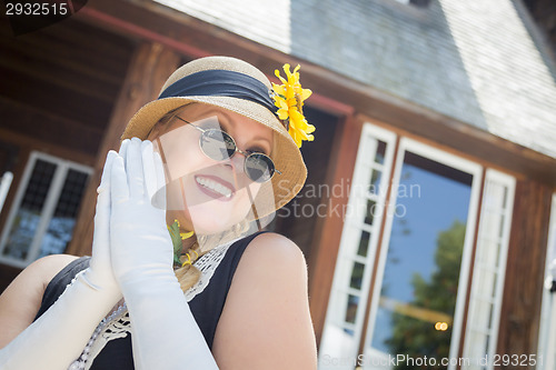 Image of Attractive Woman in Twenties Outfit Near Antique House