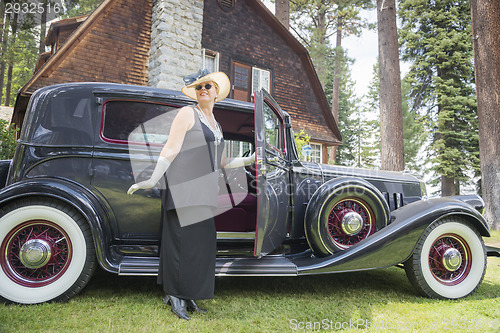 Image of Attractive Woman in Twenties Outfit Near Antique Automobile