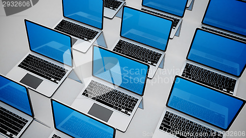 Image of 3d image of a lot of laptops in a rows.
