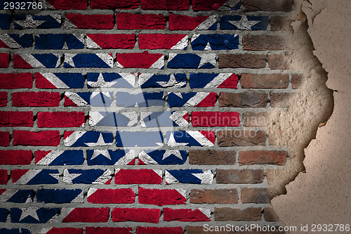 Image of Dark brick wall with plaster - Confederate flag