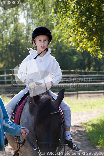 Image of little girl riding horse