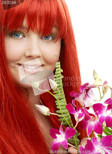 Image of lovely redhead with orchid