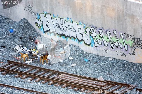Image of Two men hanging out next to railway