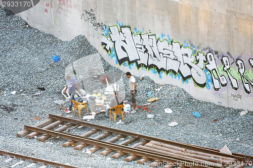 Image of Small group of men next to railway